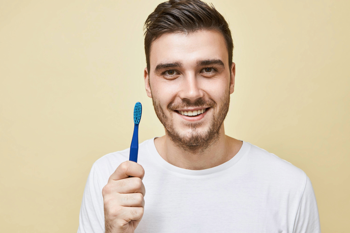 dental-hygiene-healthy-oral-area-concept-portrait-attractive-happy-young-man-doing-morning-routine-posing-isolated-with-toothbrush-going-clean-teeth-before-sleep-looking-with-smile (1)